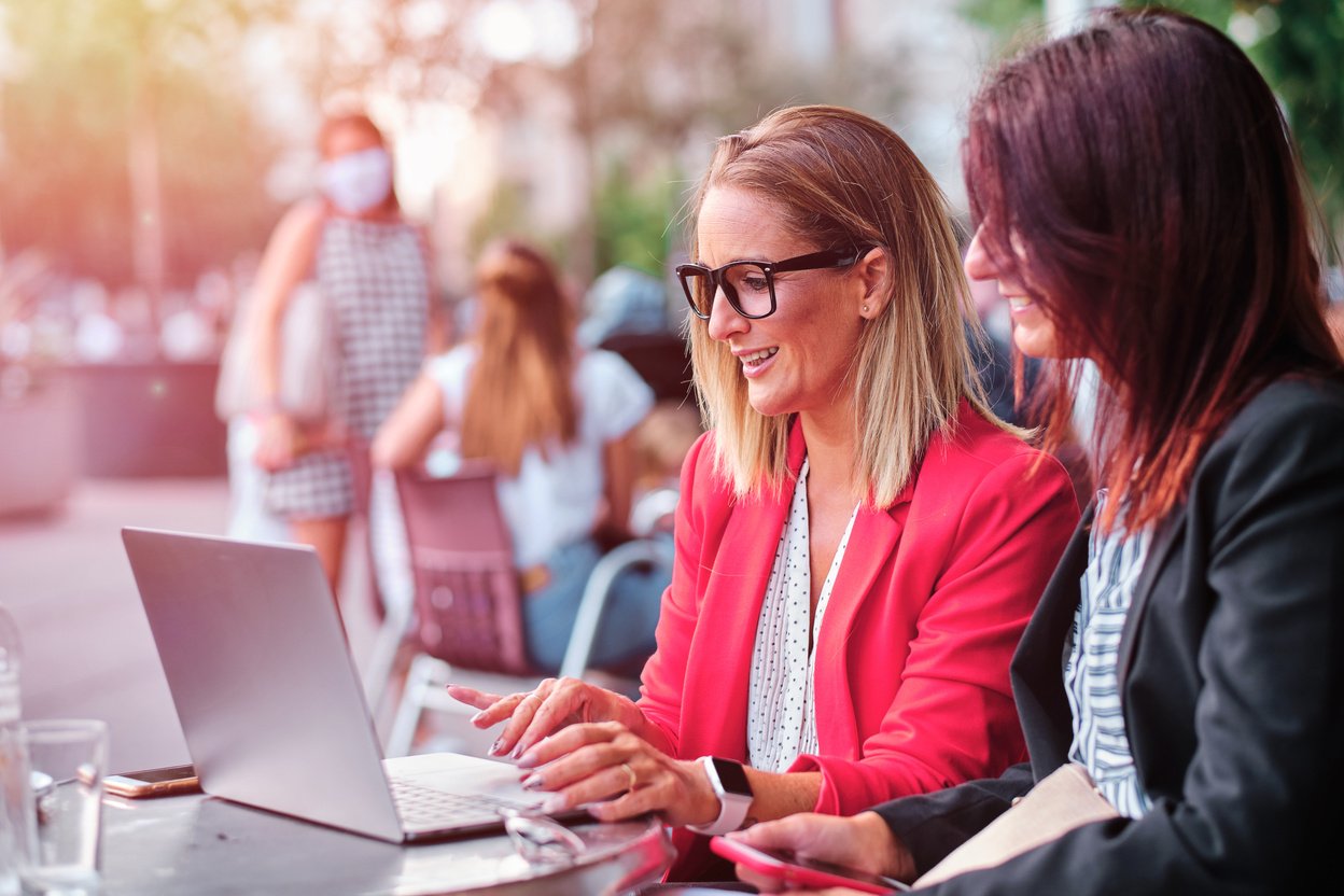 Two Adult Businesswomen Working Outdoors 